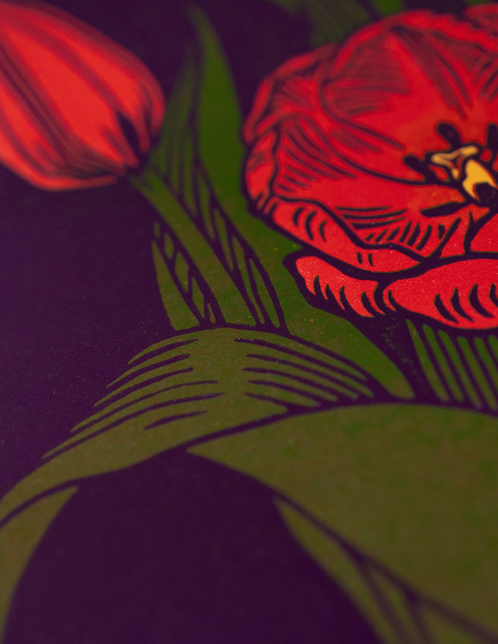 Red tulips linoprint with green leaves on a dark background
