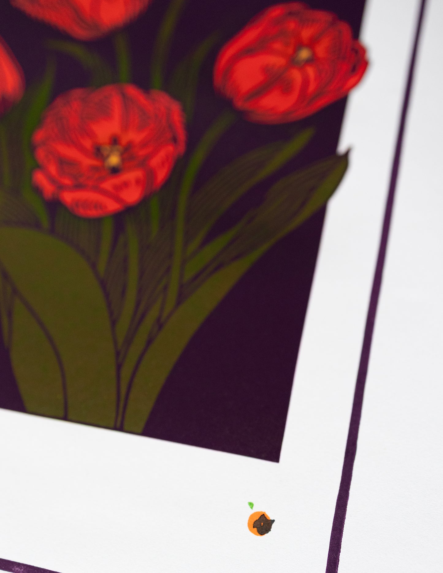 Close-up of red flowers linoprint with green leaves on a dark background