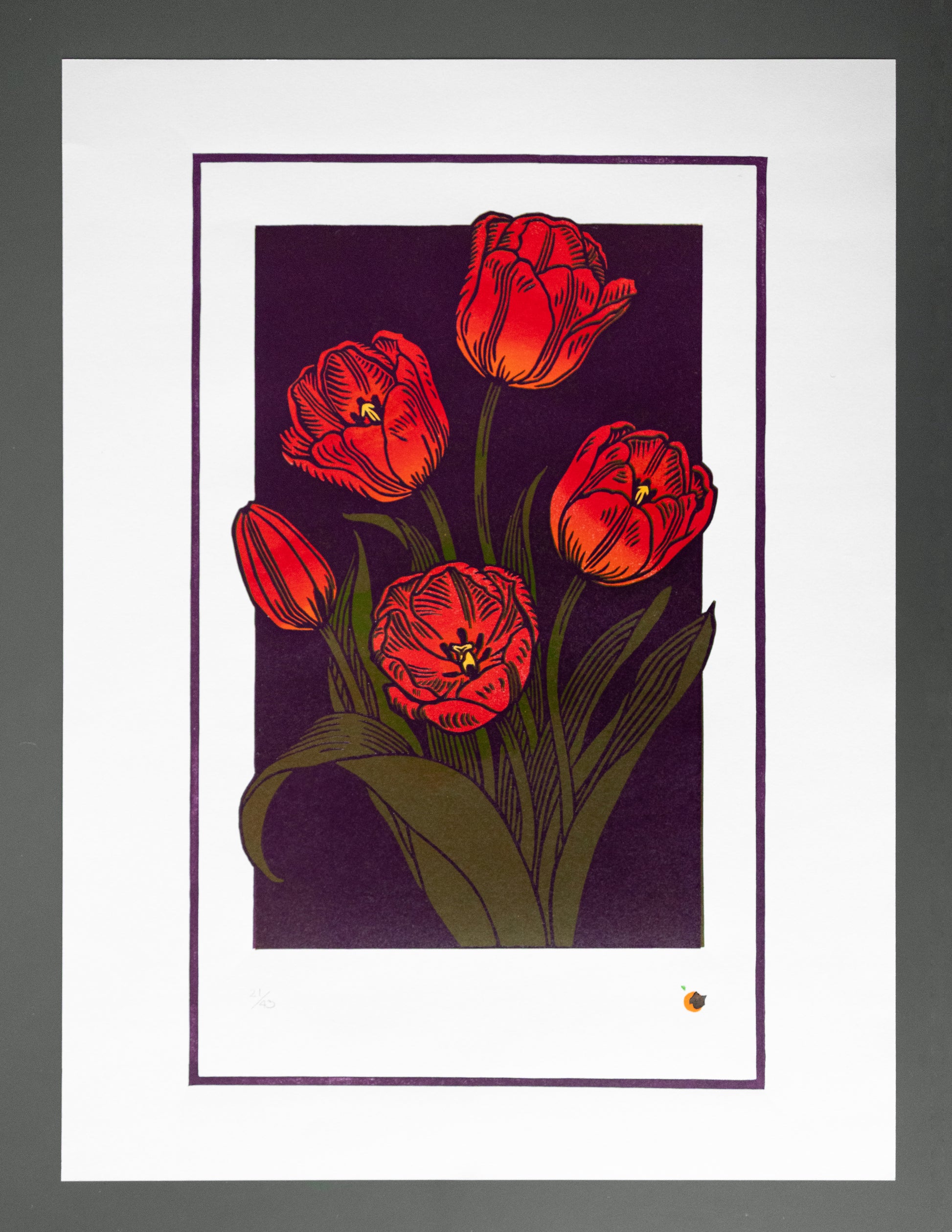 Matted artwork of red tulips linoprint on a dark purple background
